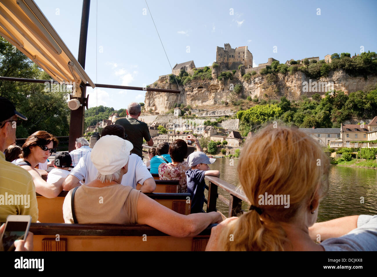 Tourists on a boat tour on the Dordogne River looking at the Chateau de Beynac, Beynac-et-Cazenac, France Europe Stock Photo