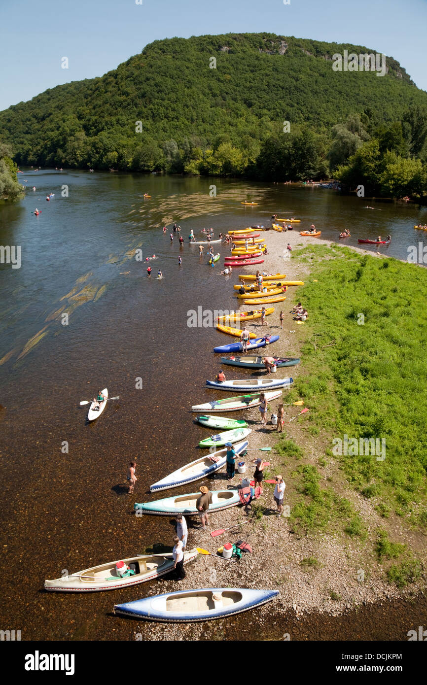 Canoes and people swimming and canoeing on the River Dordogne on summer