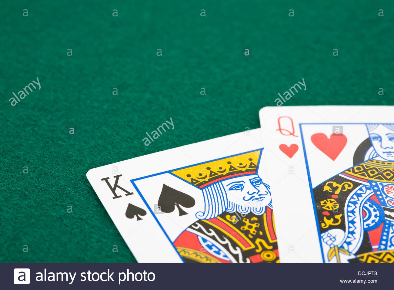 Closeup Of Queen Of Hearts And King Of Spades Playing Cards Over