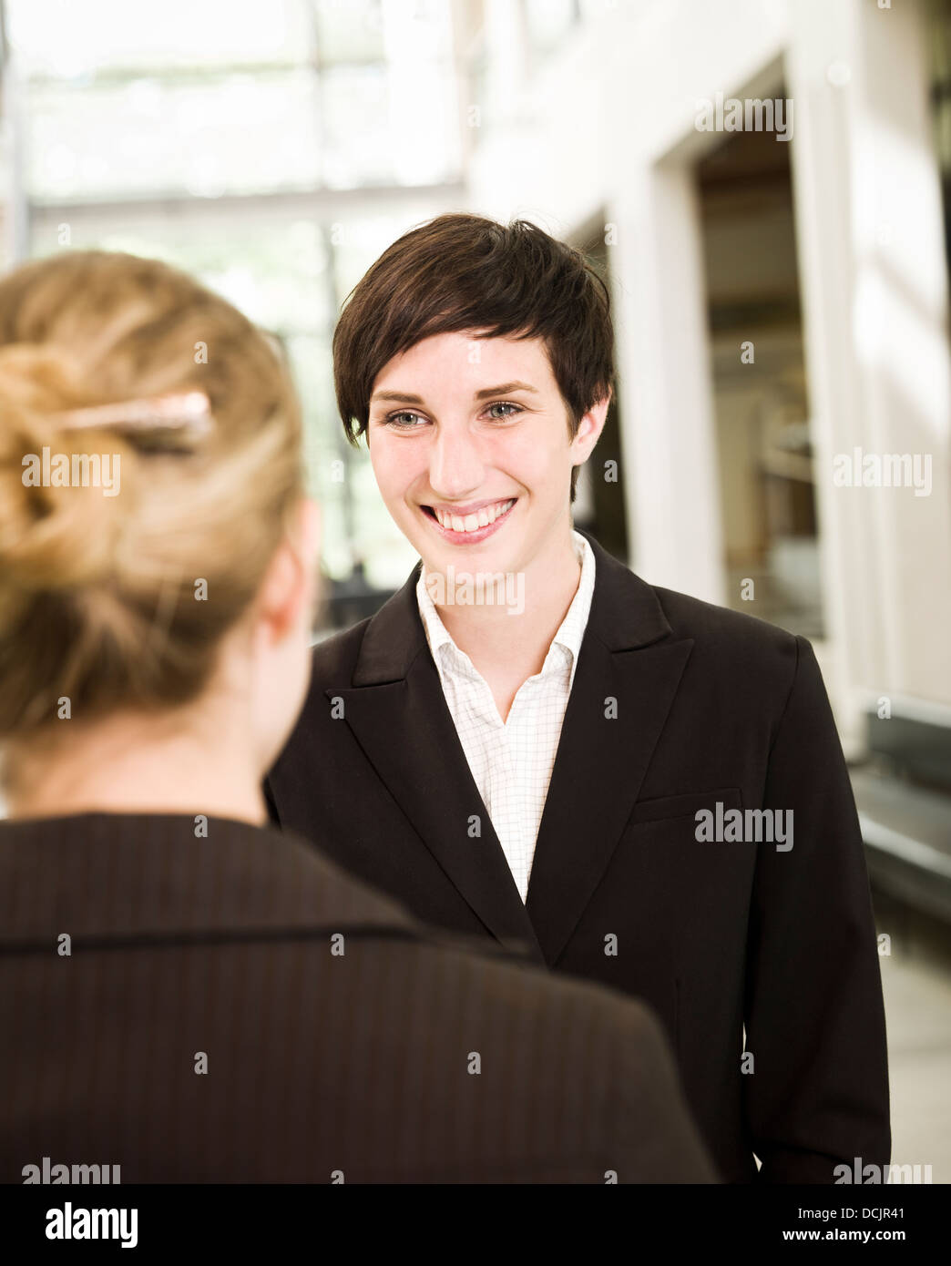 Two residents enjoying conversation in shared suite living area