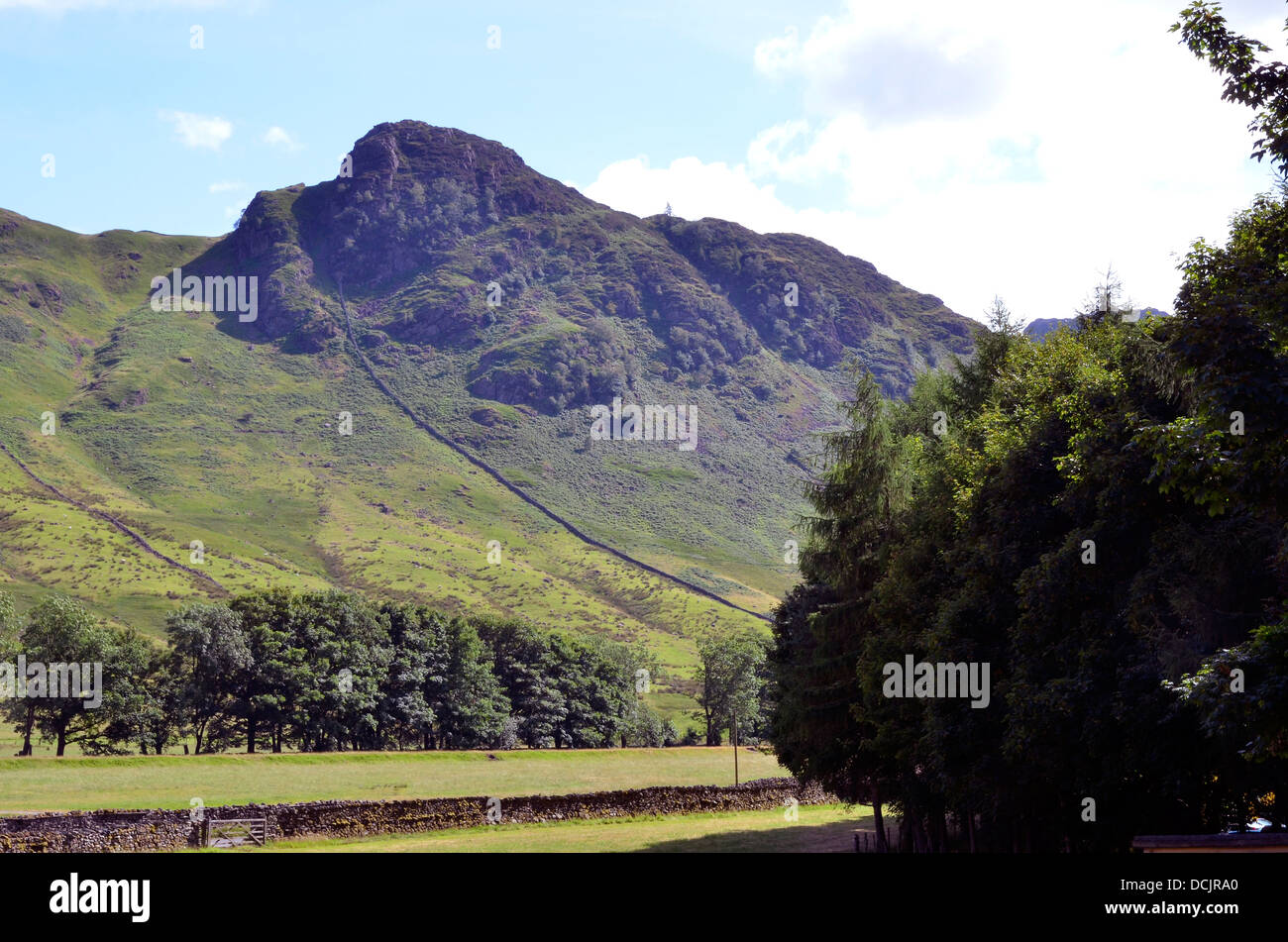Looking across Great Langdale from Dungeon Ghyll Hotel towards Side Pike with pastoral land in the valley bottom, Lake District. Stock Photo