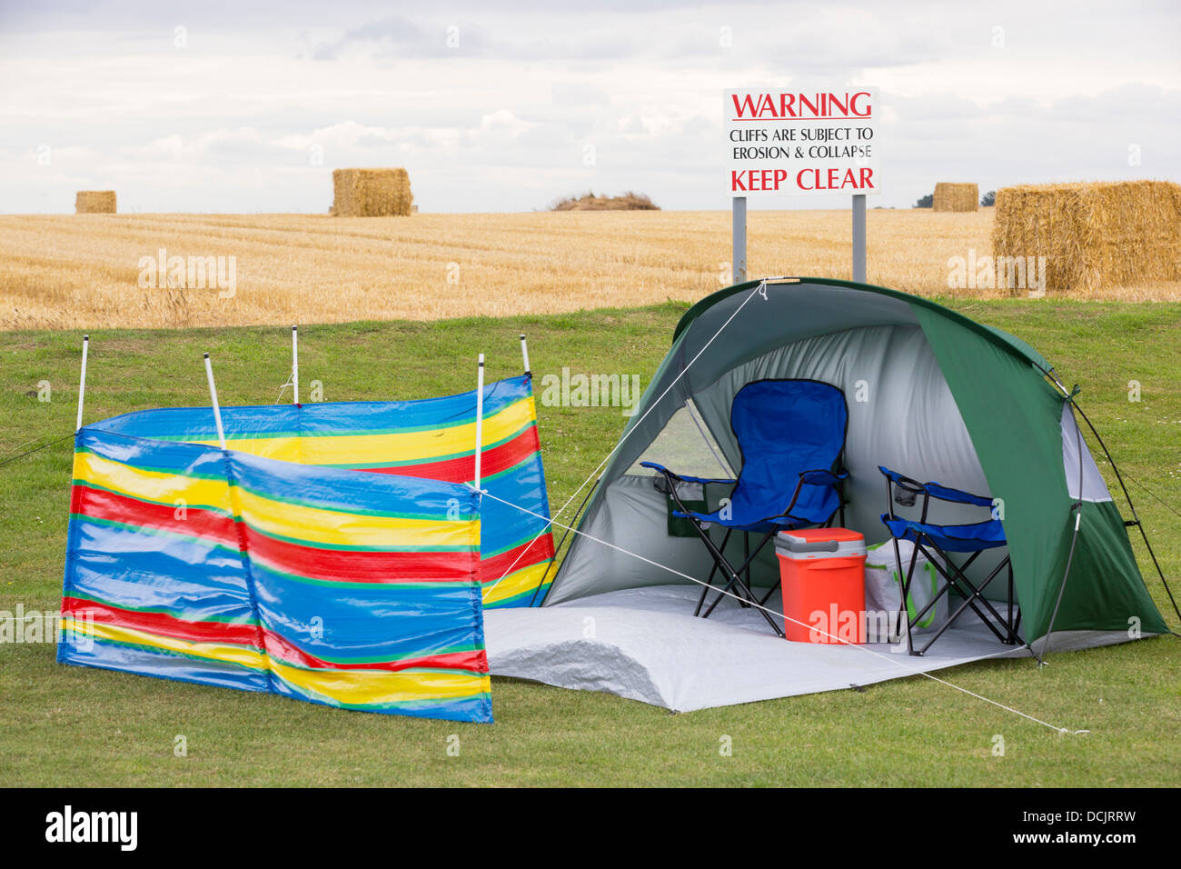 A warning sign on a caravan park near the edge of collapsing coastal cliffs at Aldbrough on Yorkshires East Coast, UK. Stock Photo