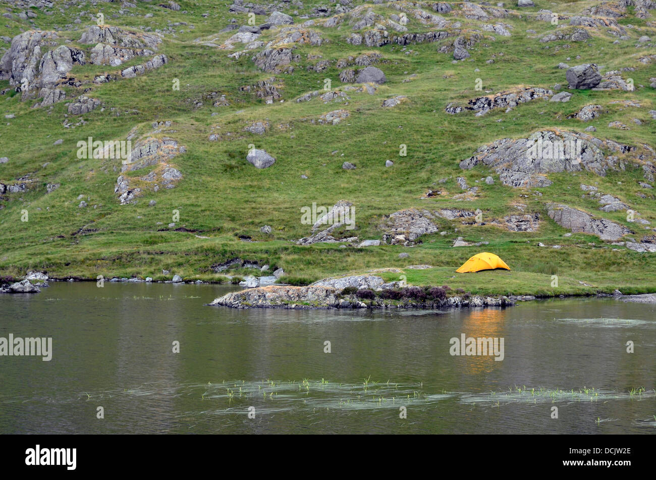 Wilderness camping Stickle Tarn, popular tourist spot above the Langdale valley in the Lake District National Park. Stock Photo