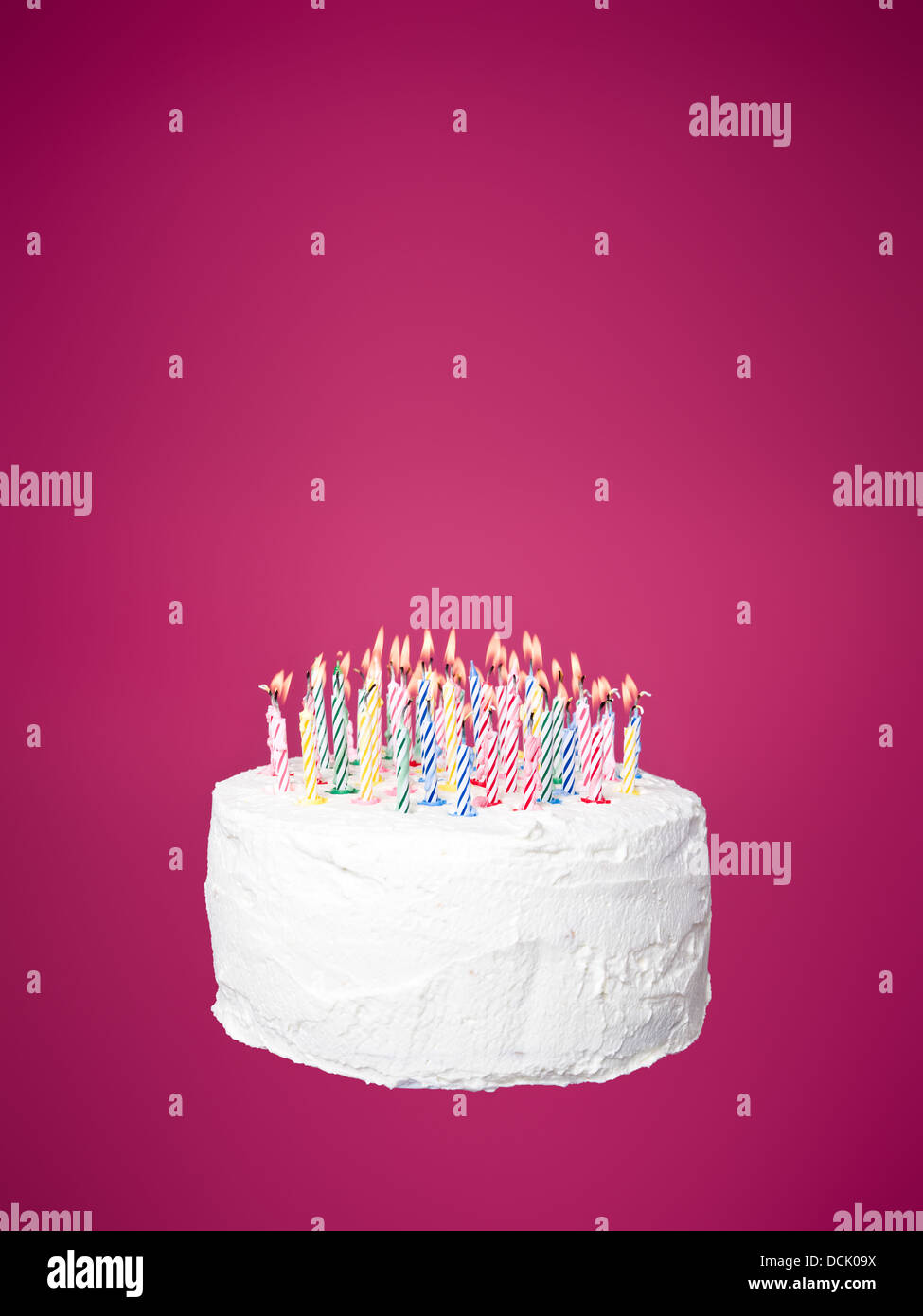 Cake with candles towards pink background Stock Photo - Alamy