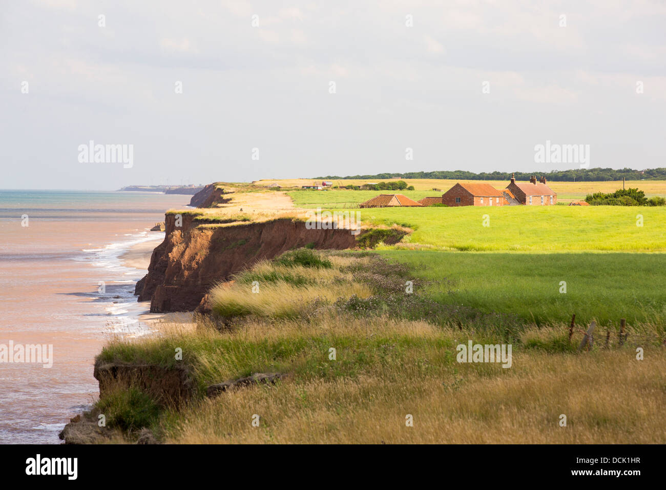 A farm house near the edge of collapsing coastal cliffs at Aldbrough on Yorkshires East Coast, UK. Stock Photo