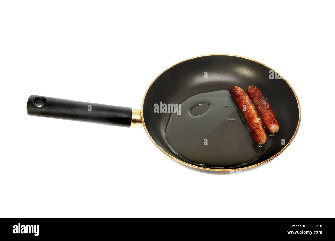 Sausages cooking in a frying pan isolated against white Stock Photo