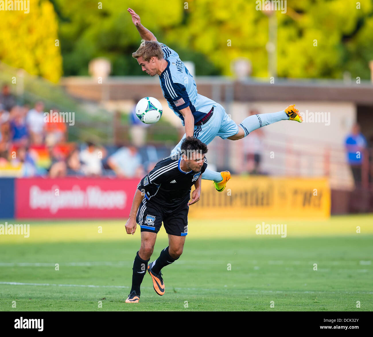 Santa Clara, CA. 18th Aug, 2013. August 18, 2013: Sporting KC defender Chance Myers (7) draws a yellow card for leaping on the back of San Jose Earthquakes forward Chris Wondolowski (8) during the MLS soccer game between the San Jose Earthquakes and Sporting Kansas City at Buck Shaw Stadium in Santa Clara, CA. The Earthquakes defeated Kansas City 1-0. © Cal Sport Media/Alamy Live News Stock Photo