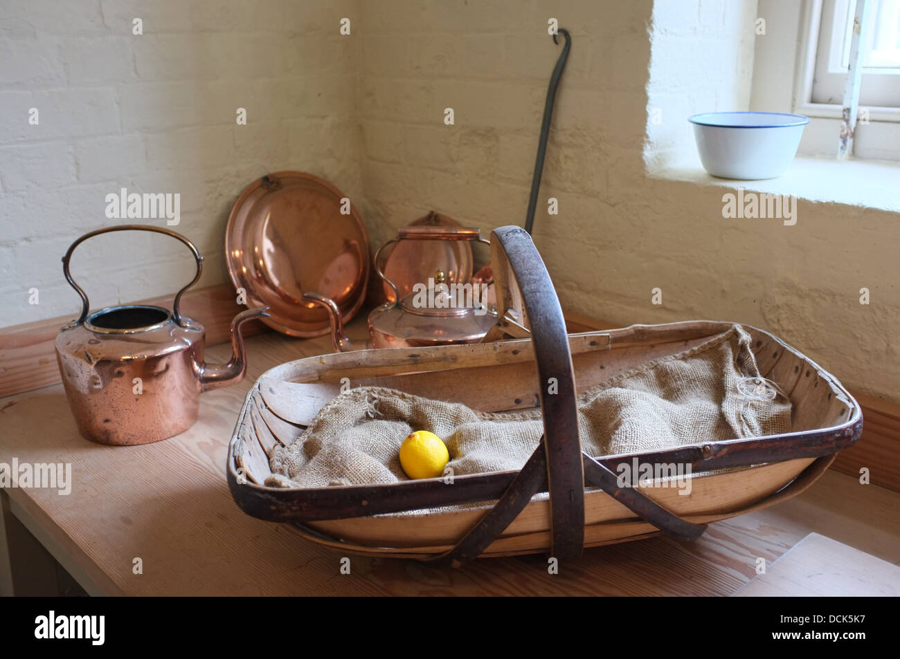 https://c8.alamy.com/comp/DCK5K7/victorian-kitchen-basket-with-a-single-lemon-copper-tea-pot-and-pans-DCK5K7.jpg