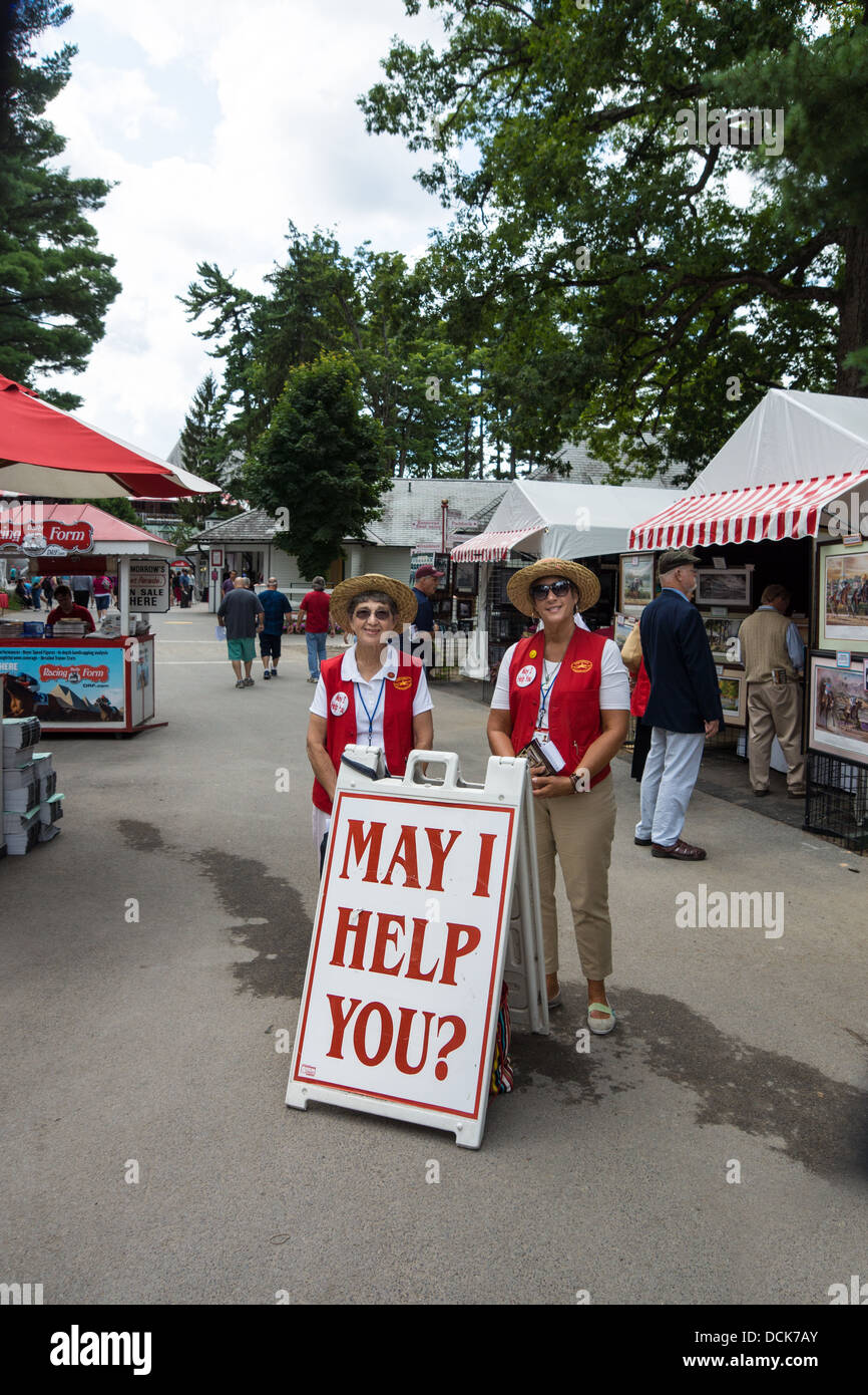 Two friendly women are ready to help visitors at the  entrance to the Saratoga Raceway in Saratoga, New York. Stock Photo