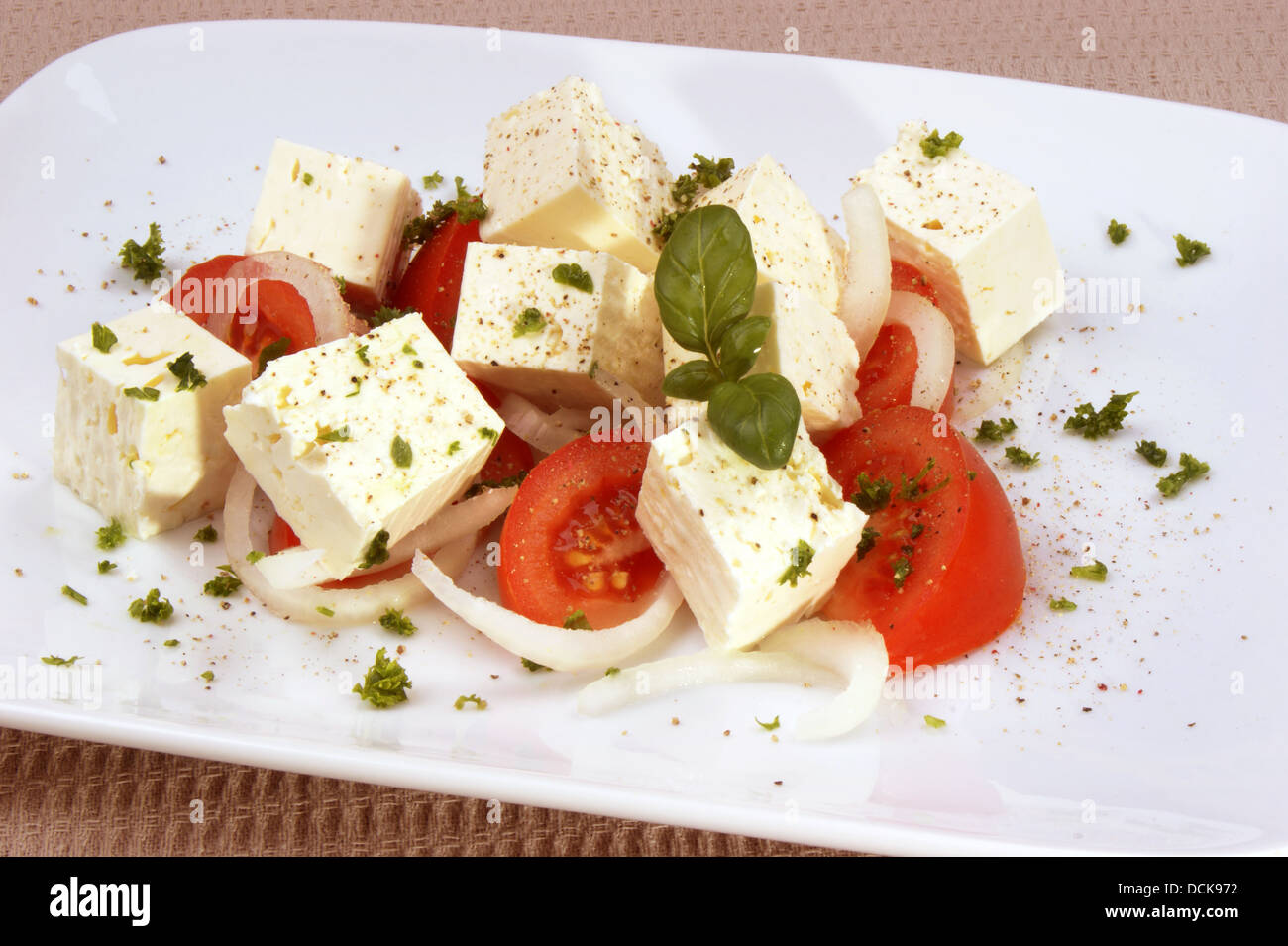 Greek goat cheese with tomato and basil Stock Photo Alamy