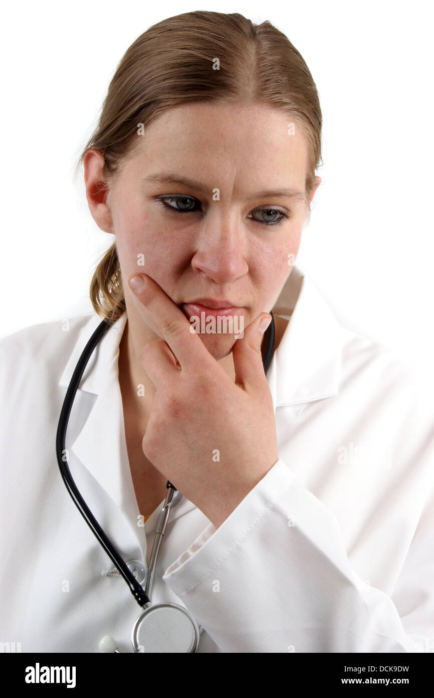 young medical assistant in a white uniform is thoughtfully Stock Photo