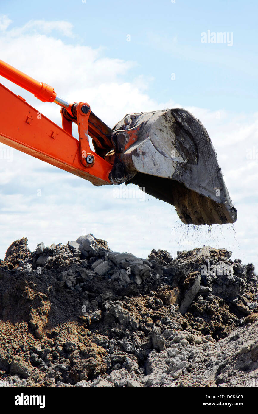 Bucket dropping clay and dirt Stock Photo Alamy