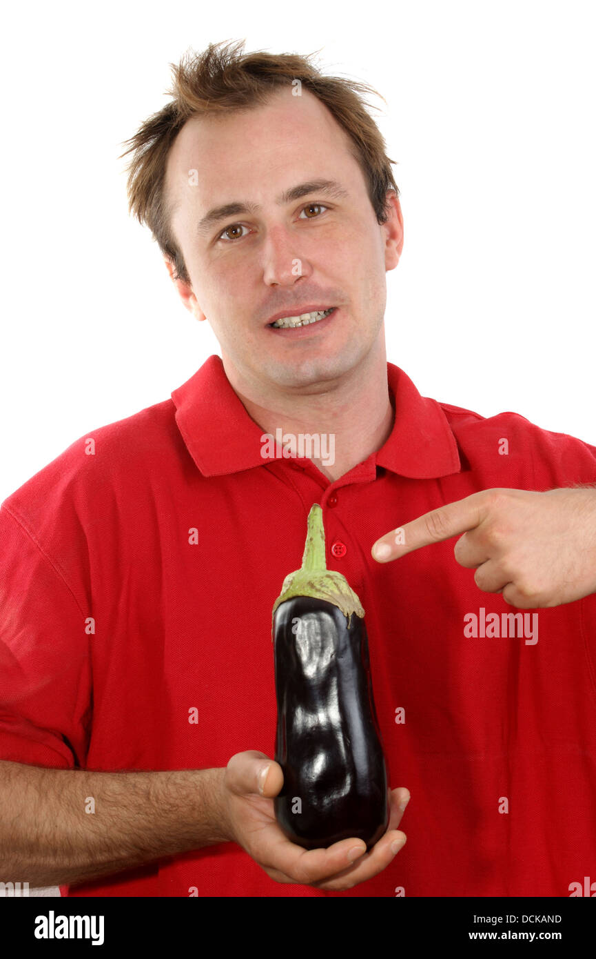 young man with an eggplant in his hand Stock Photo - Alamy
