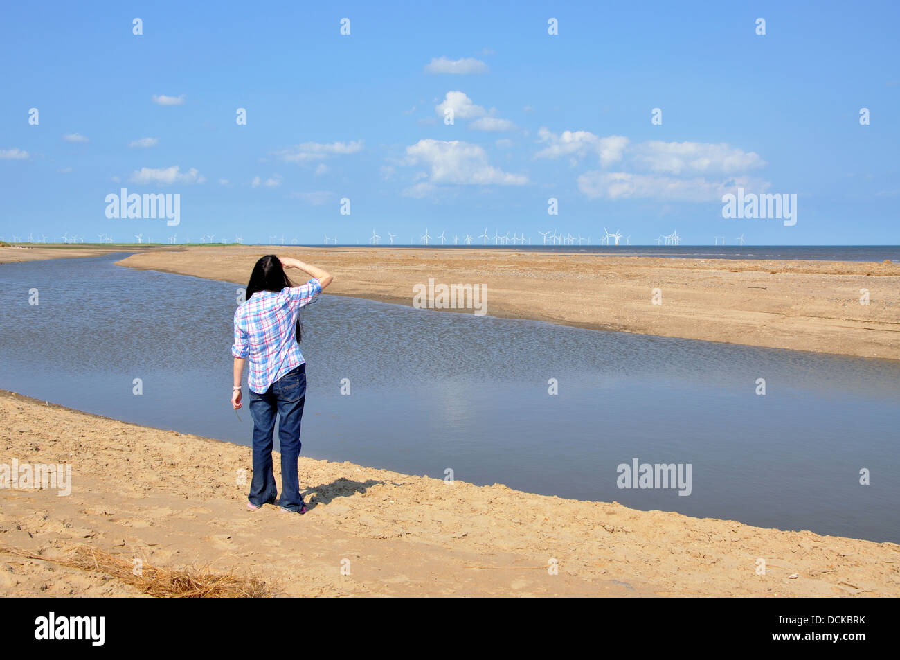 woman looking out to sea, Gibraltar Point nature reserve, near Skegness, Lincolnshire, England, UK Stock Photo