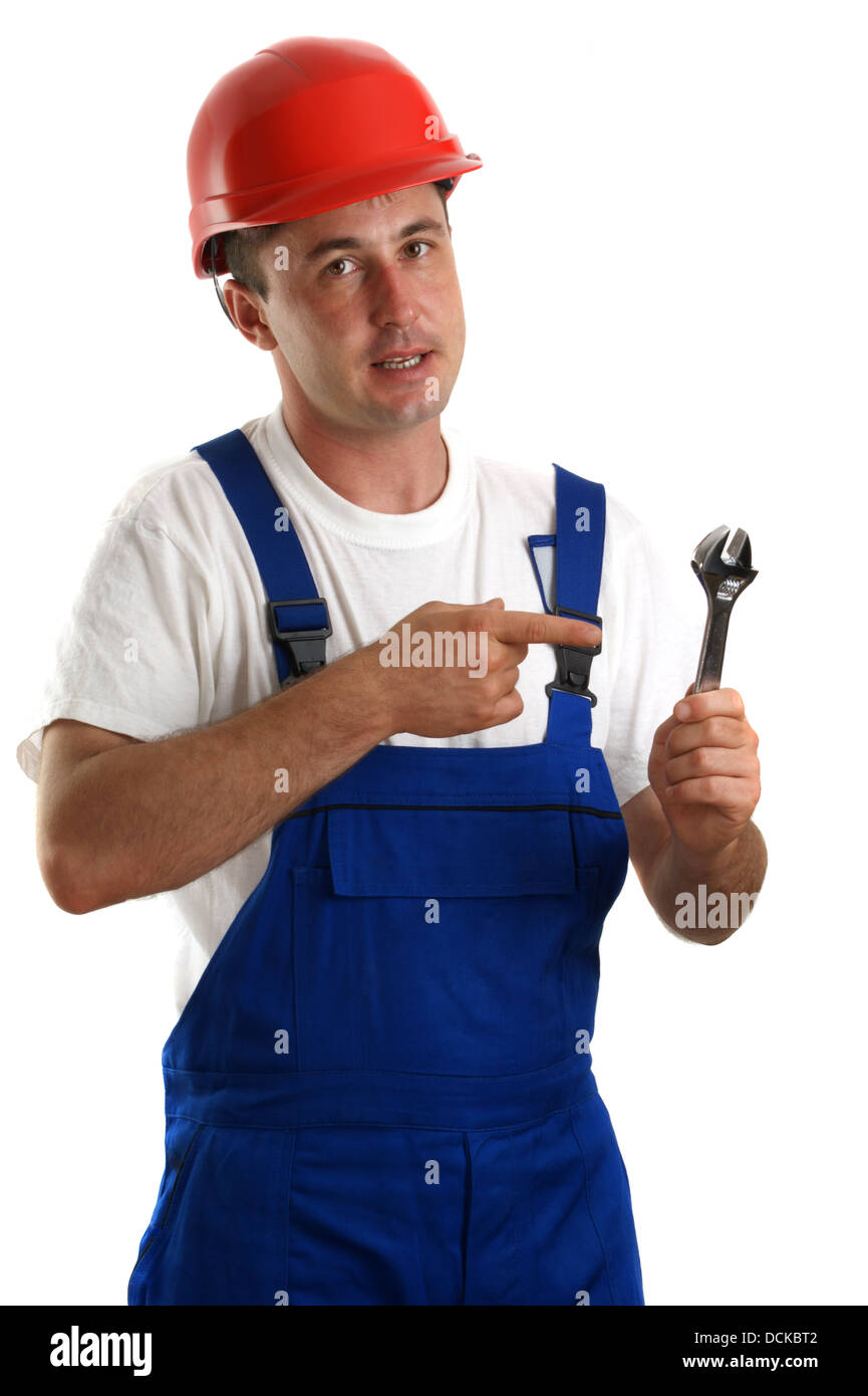 Craftsmen in work clothes holding an adjustable wrench Stock Photo