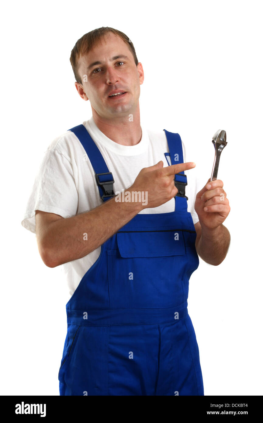 Craftsmen in work clothes holding an adjustable wrench Stock Photo