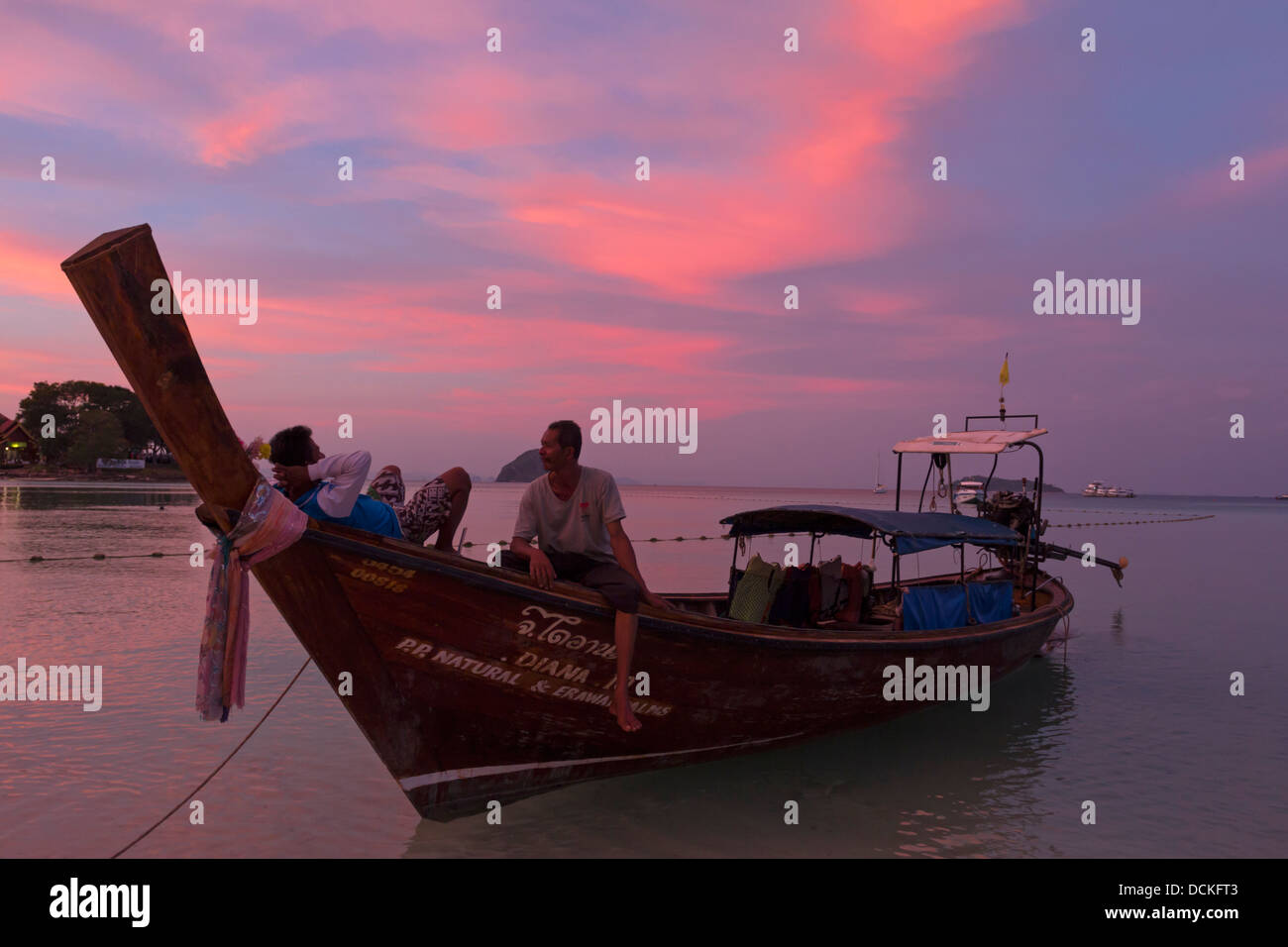 Local men relaxing on Longtail Boat - Ko Phi Phi Don - Krabi Province - Thailand Stock Photo