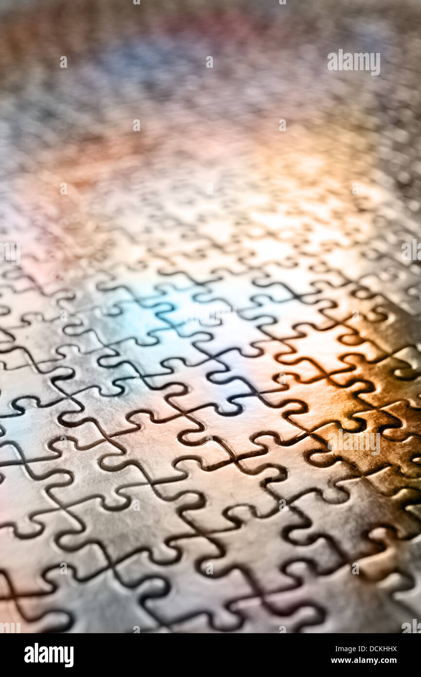 Jigsaw puzzle interlocking pieces pattern to solve meshed together in one correct outcome as each piece a unique shape Stock Photo