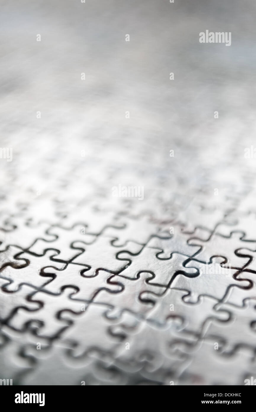 Jigsaw puzzle interlocking pieces pattern to solve meshed together in