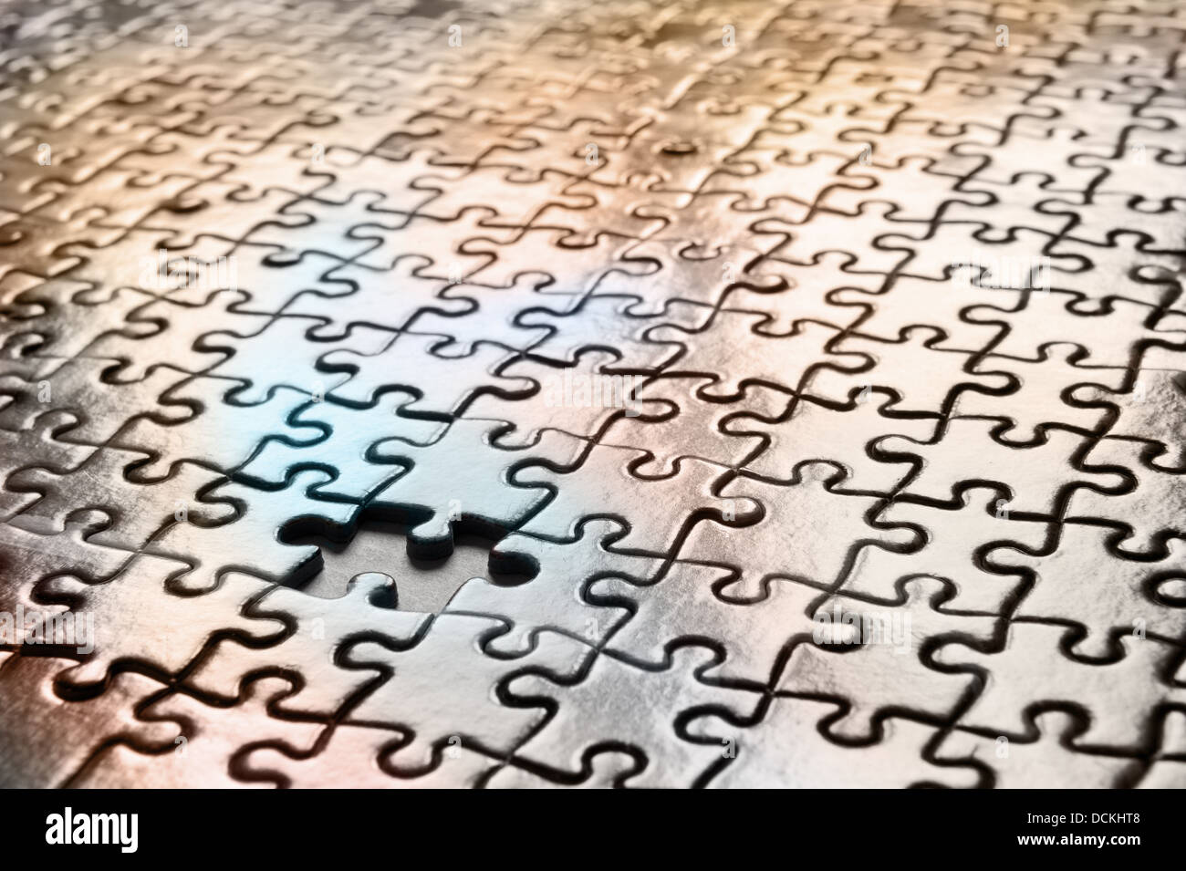 missing jigsaw puzzle interlocking pieces pattern to solve meshed together in one correct outcome as each piece a unique shape Stock Photo