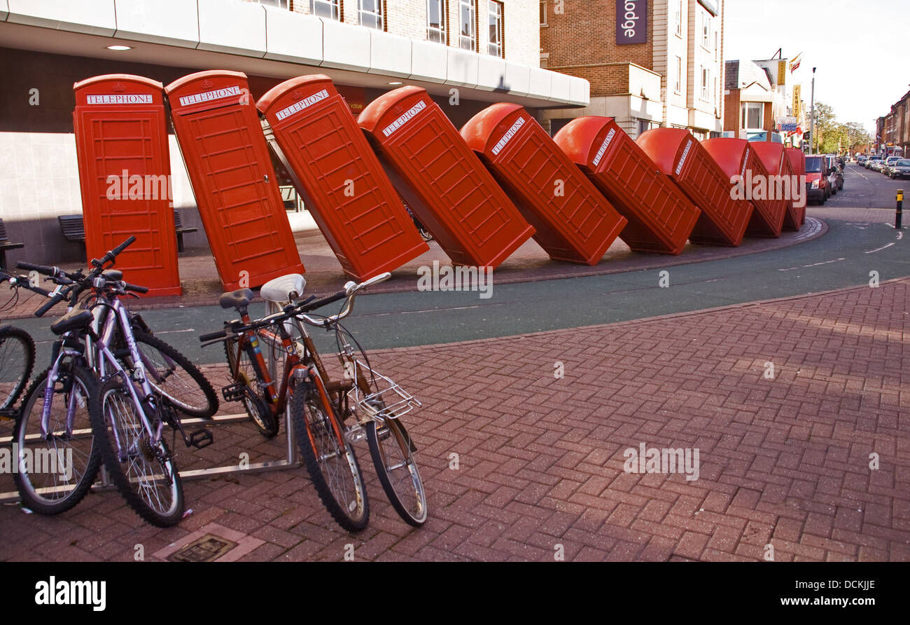 English red telephone boxes falling over each other. Stock Photo