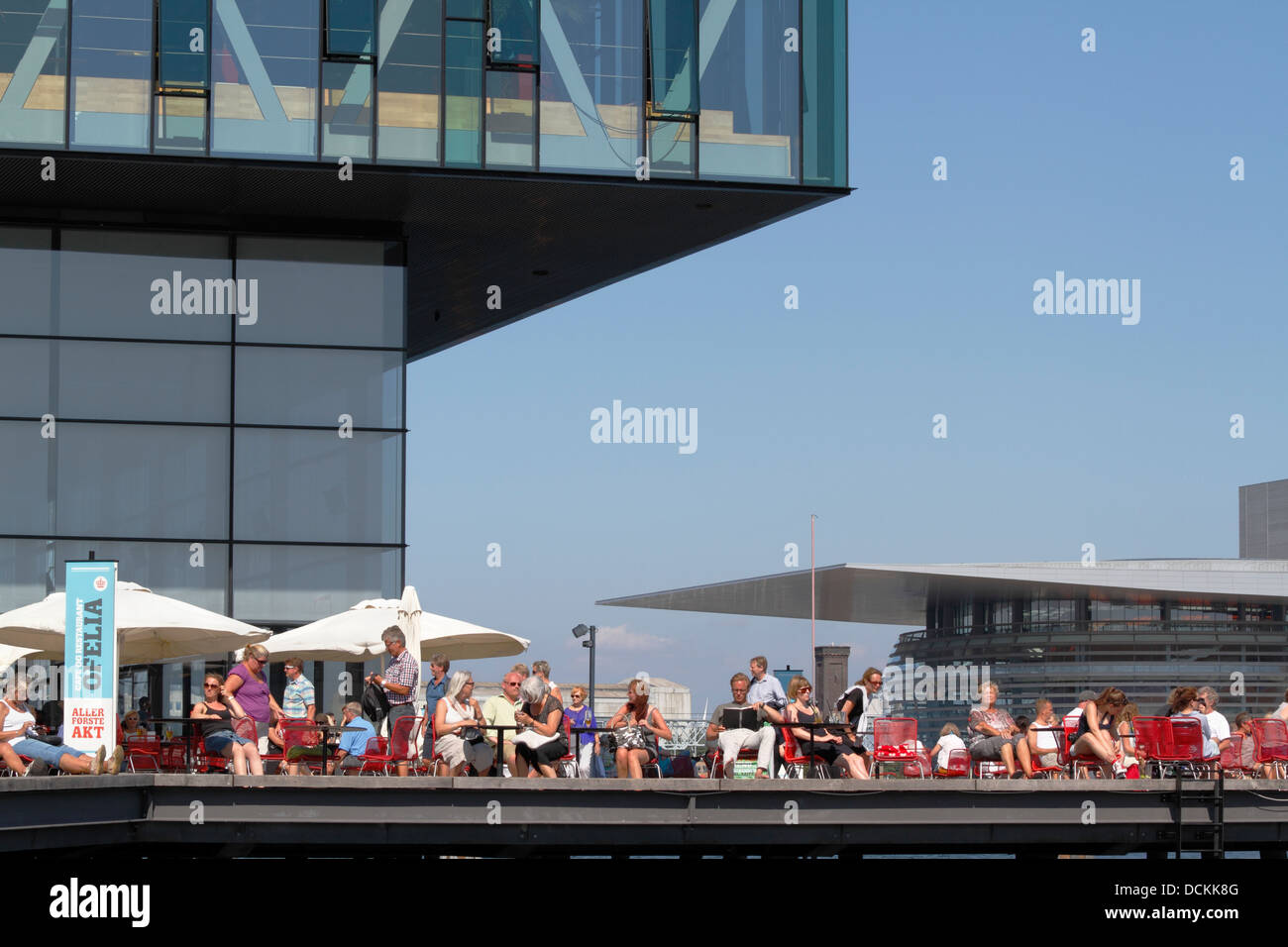 The Royal Danish Playhouse with dockside restaurant Ofelia in Copenhagen harbour. The Royal Danish Opera House seen on opposite side of harbour canal. Stock Photo
