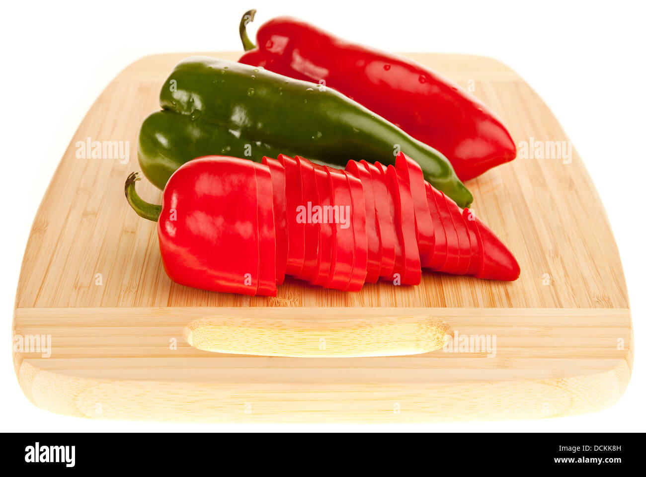 red and green peppers on a board Stock Photo - Alamy
