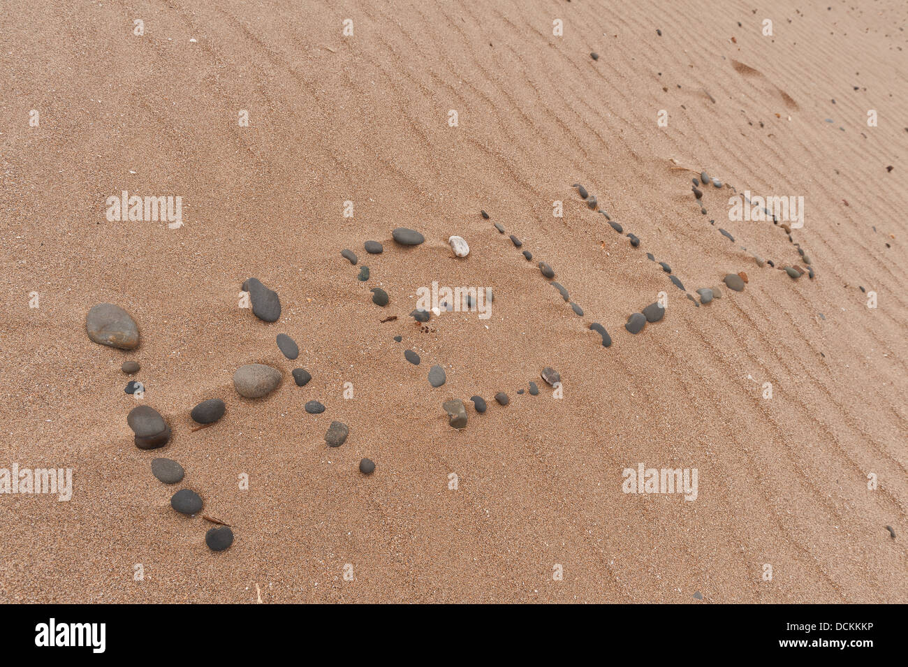 Hello word made from pebbles made at low tide as sea leaves beach ...