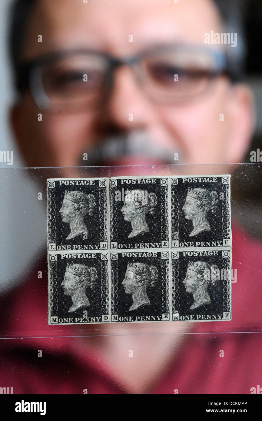 Brno, Czech Republic. 20th Aug, 2013. Penny Black stamps, world's first adhesive postage stamps in Brno. 20th Aug, 2013. Richard Burda shows a block of Penny Black stamps, world's first adhesive postage stamps in Brno, Czech Republic, August 20, 2013. Rare stamps will be auctioned by Burda Auction company at the weekend in Prague, the starting price is 1.9 million. © Vaclav Salek/CTK Photo/Alamy Live News Credit:  CTK/Alamy Live News Stock Photo