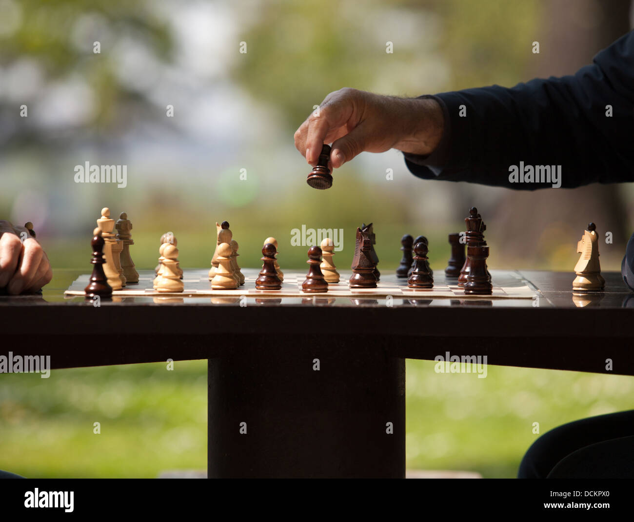 man playing chess, making the move Stock Photo - Alamy