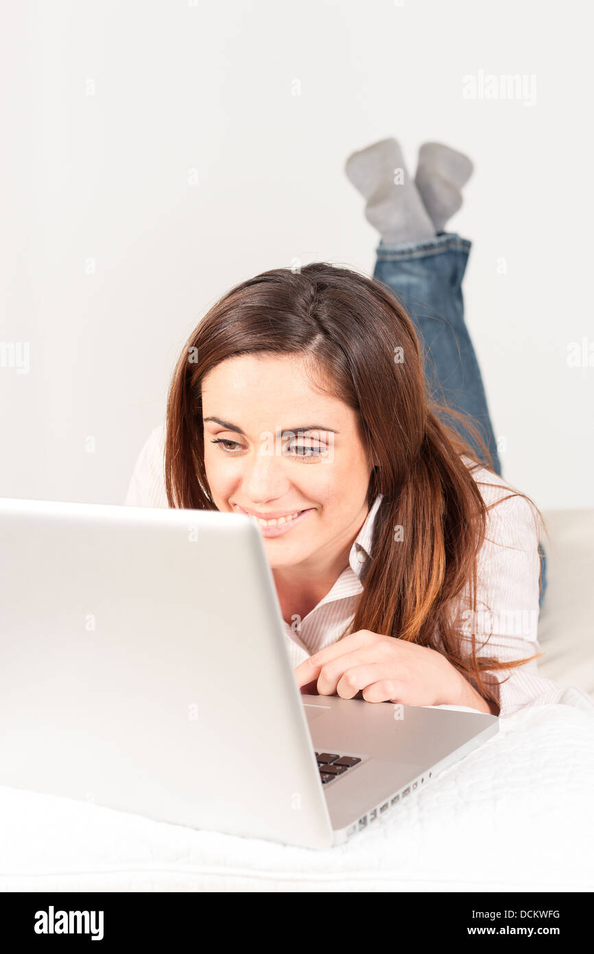 beautiful woman using laptop on sofa Stock Photo - Alamy