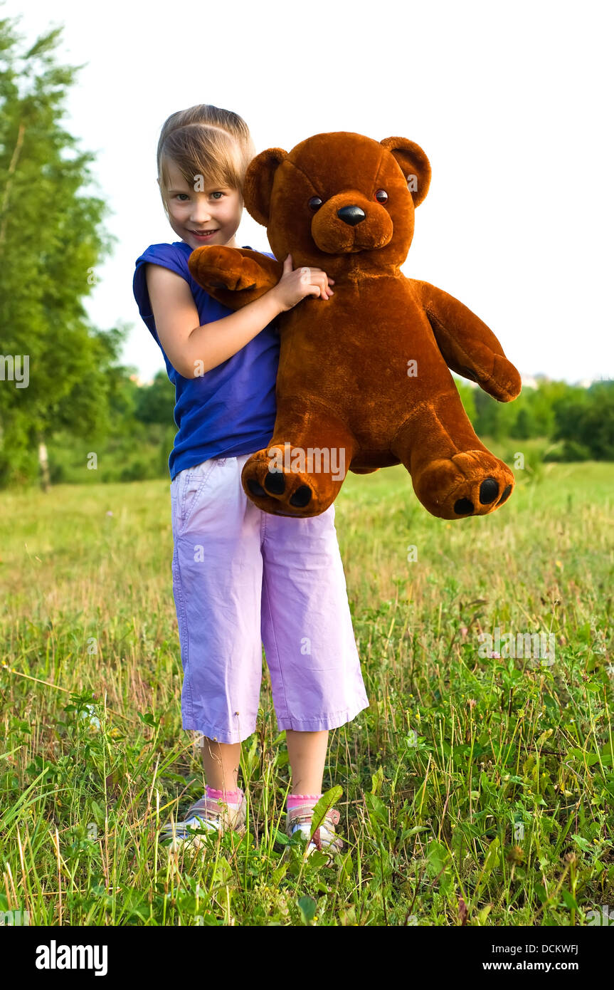 girl with teddy bear in a meadow Stock Photo - Alamy