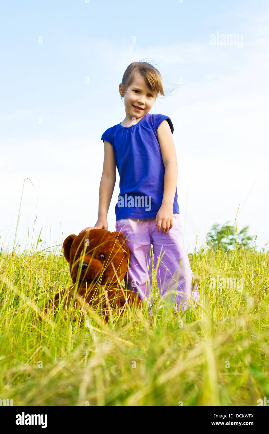 girl with teddy bear in a meadow Stock Photo - Alamy