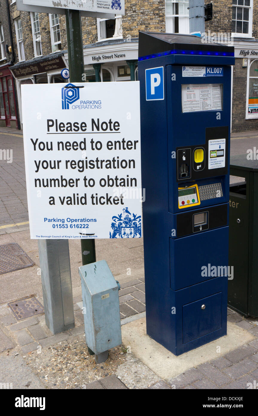 A sign tells motorists to enter their car number to obtain a valid parking ticket. Stock Photo