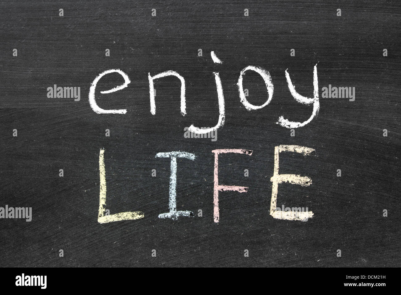 enjoy life phrase handwritten on the school blackboard Stock Photo