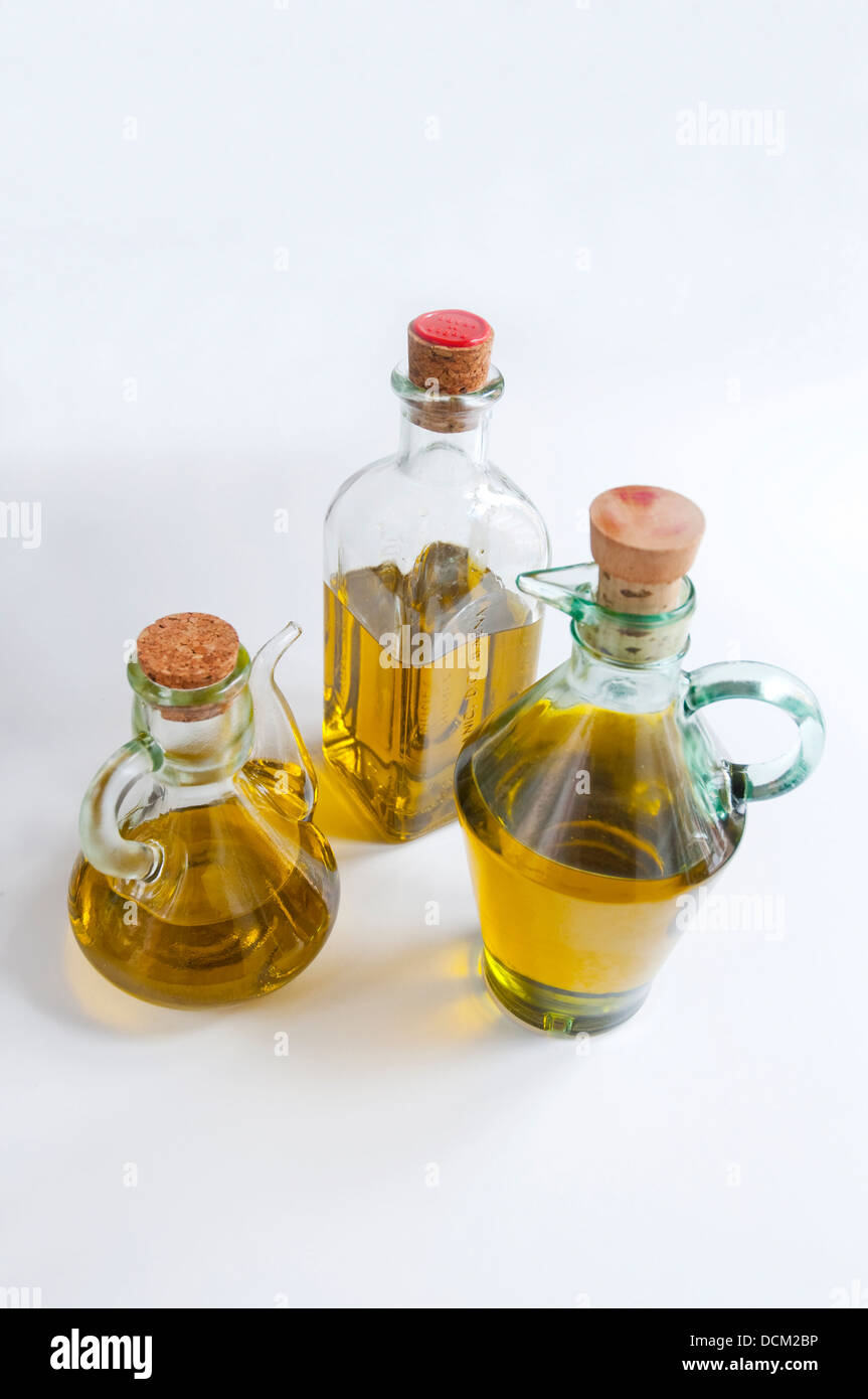 Three oil bottles filled with extra virgin olive oil from Spain. Still life. Stock Photo