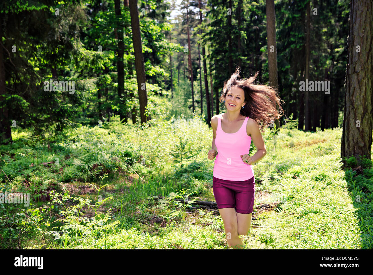 young woman jogging in a forest Stock Photo - Alamy