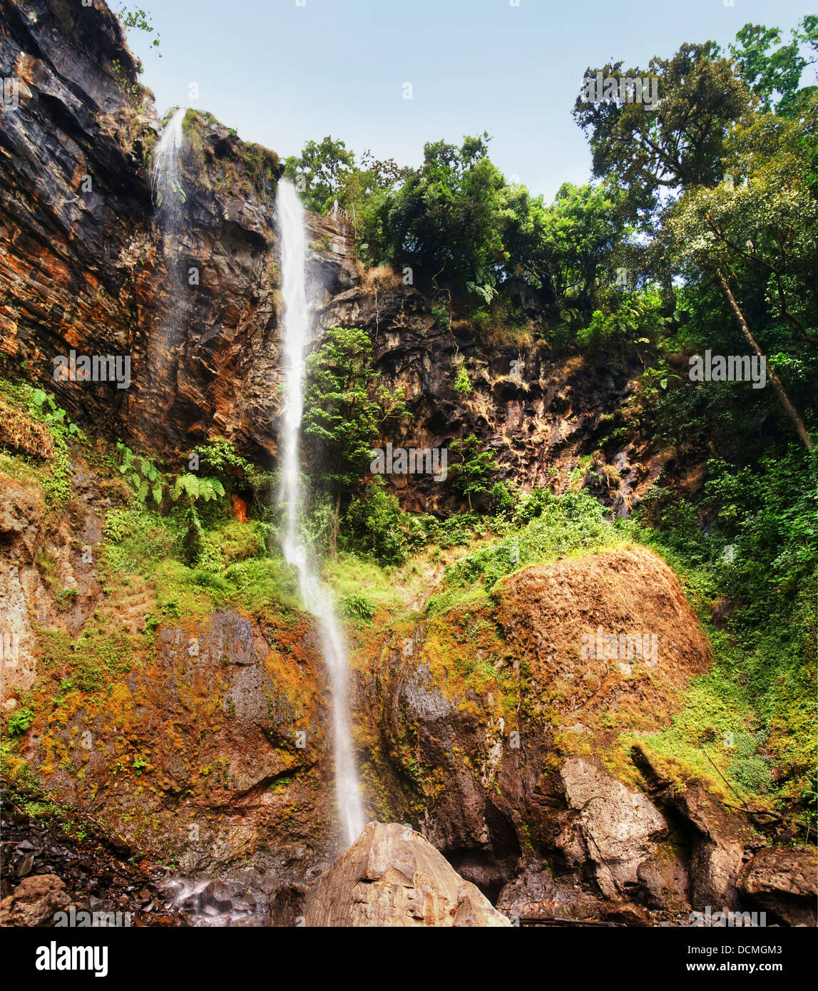 Sacred waterfall in a deep canyon of tropical forest Stock Photo