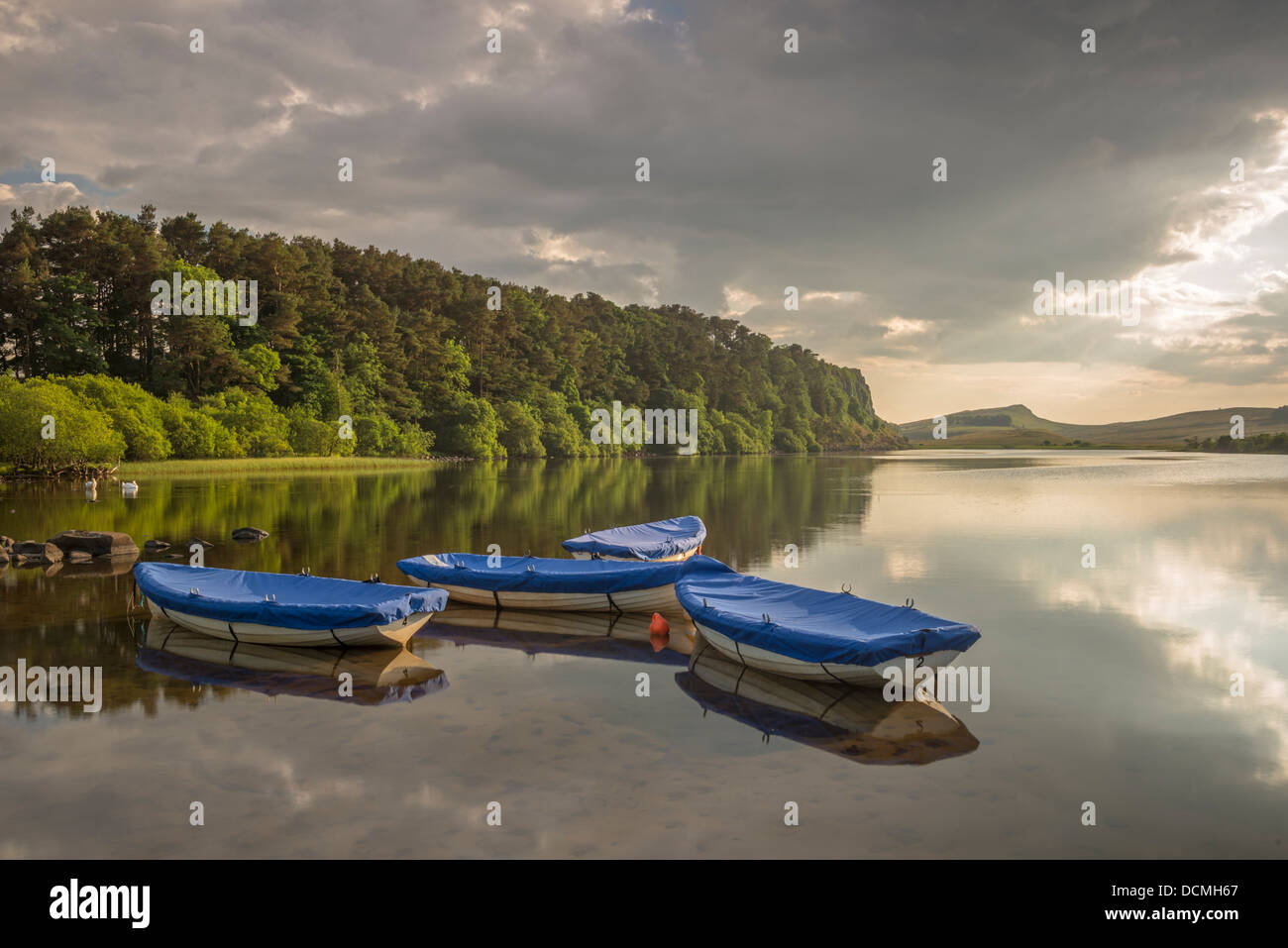 Boats on Crag Lough in Hadrian's Wall Country on a summer's evening, Northumberland, England Stock Photo