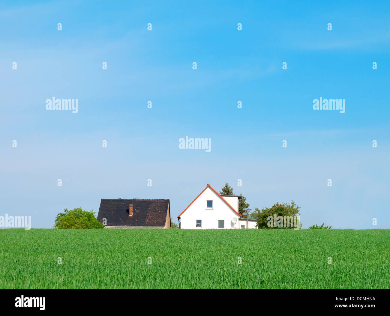 House on green agriculture field Stock Photo - Alamy