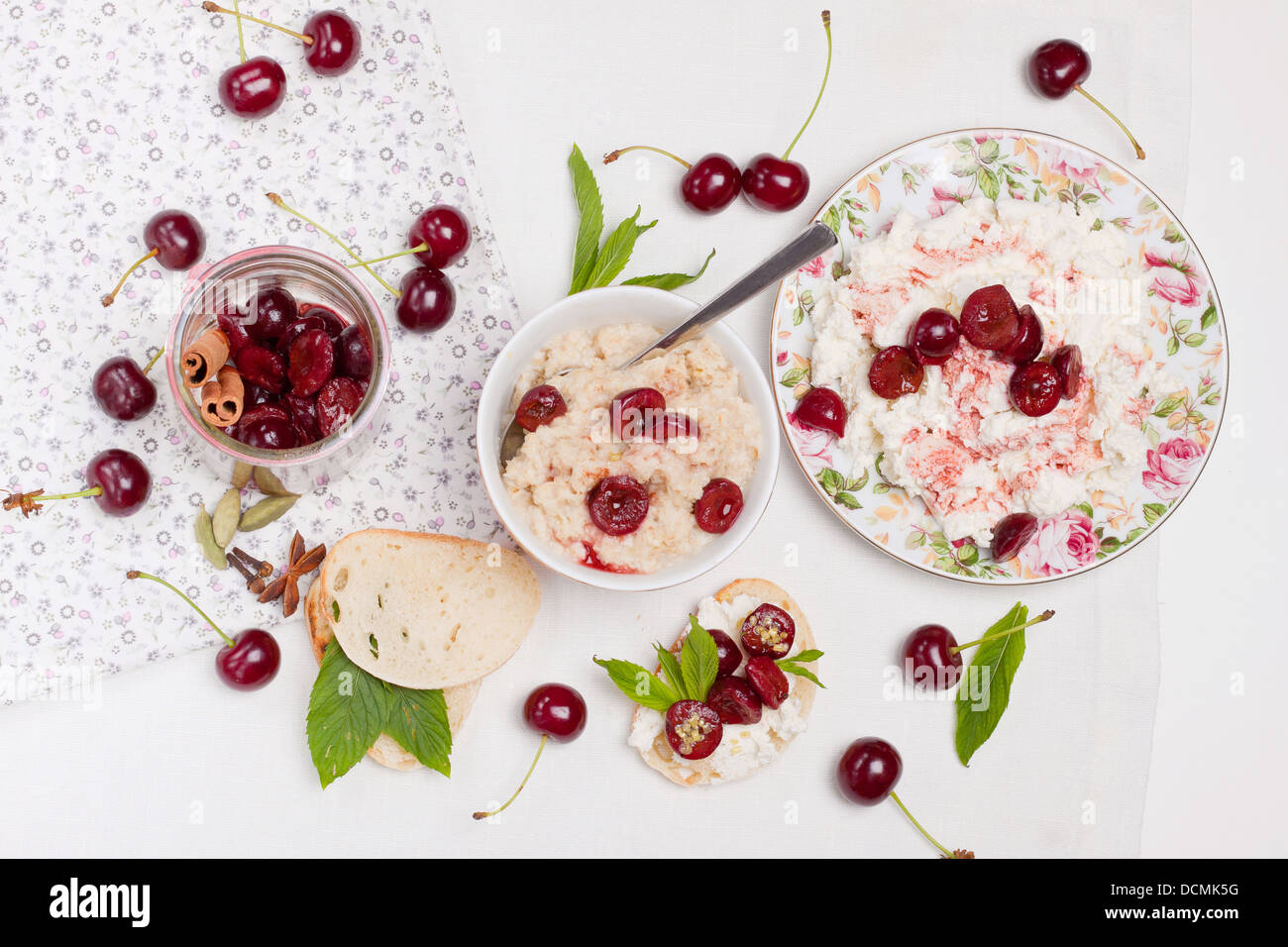 Breakfast dishes garnished with chopped cherries and mint leaves Stock Photo