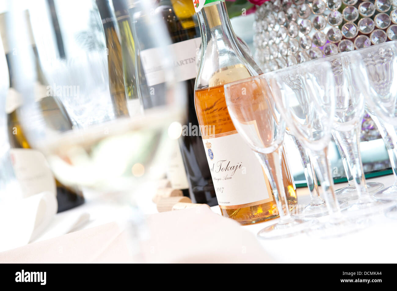 bottles of wine and glasses at function Stock Photo