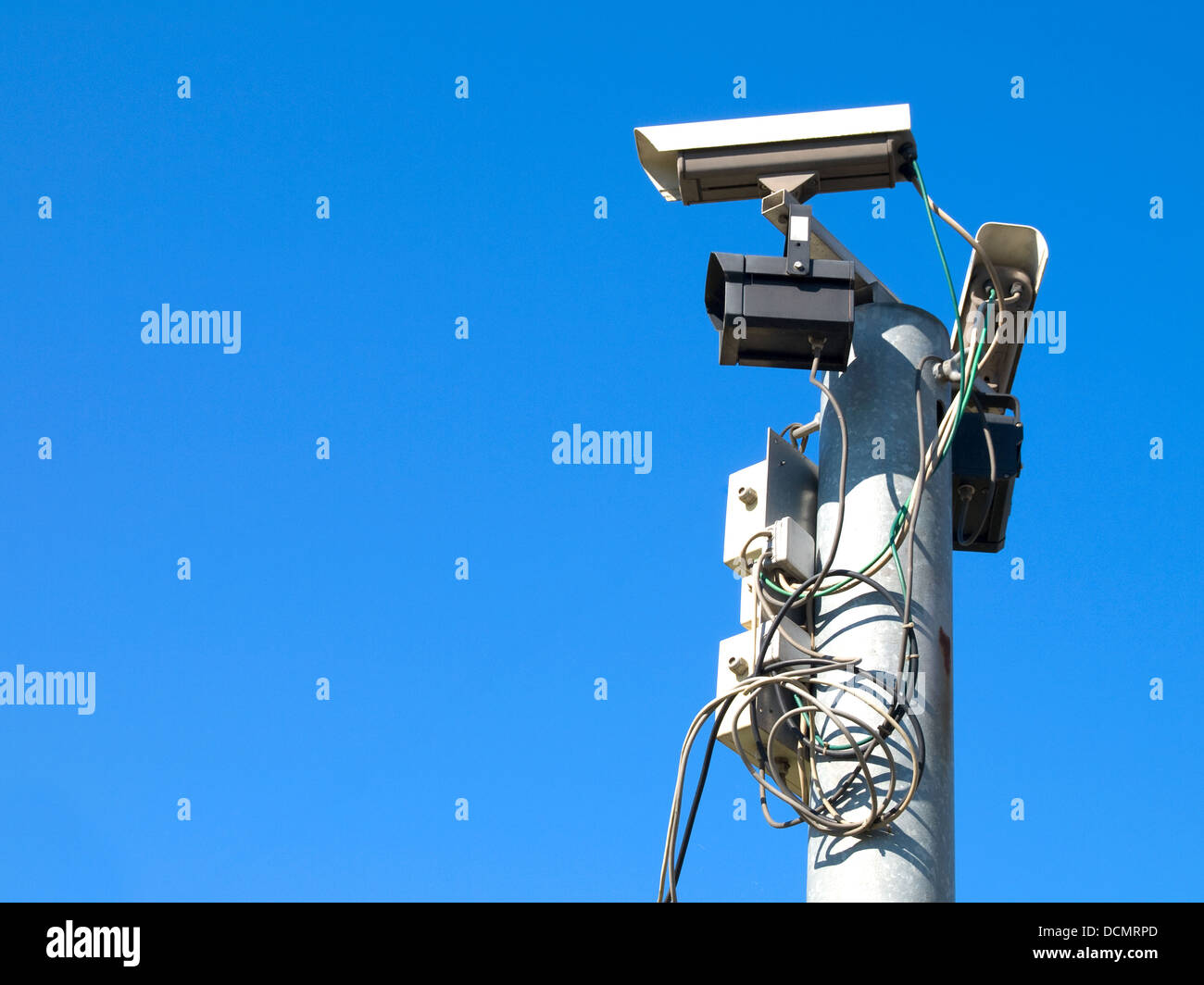 Surveillance cameras against blue sky Stock Photo - Alamy