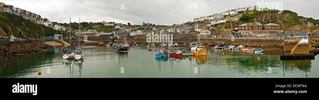 Horizontal panoramic view across the harbour at Mevagissey on a dark cloudy day. Stock Photo