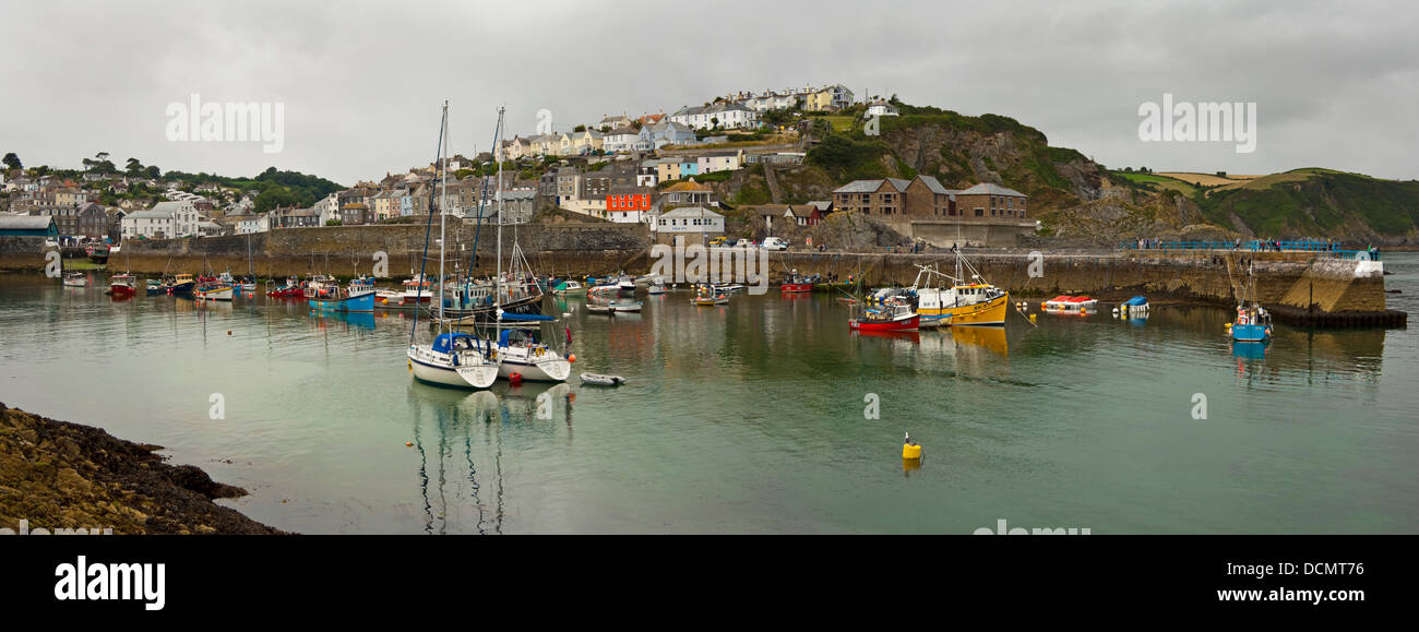 Horizontal panoramic view across the harbour at Mevagissey on a dark cloudy day. Stock Photo