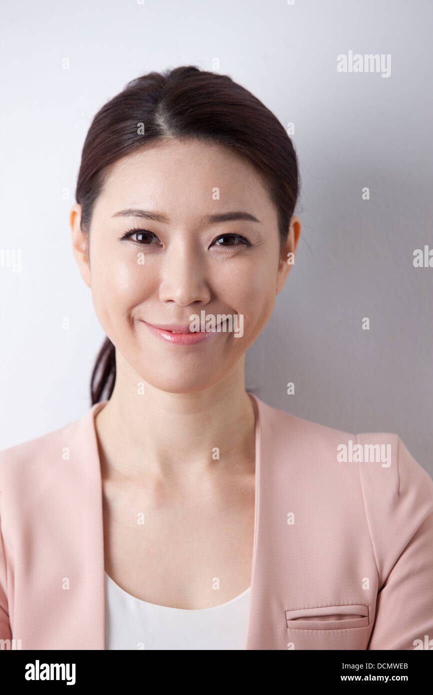 a woman in business suit smiling Stock Photo - Alamy
