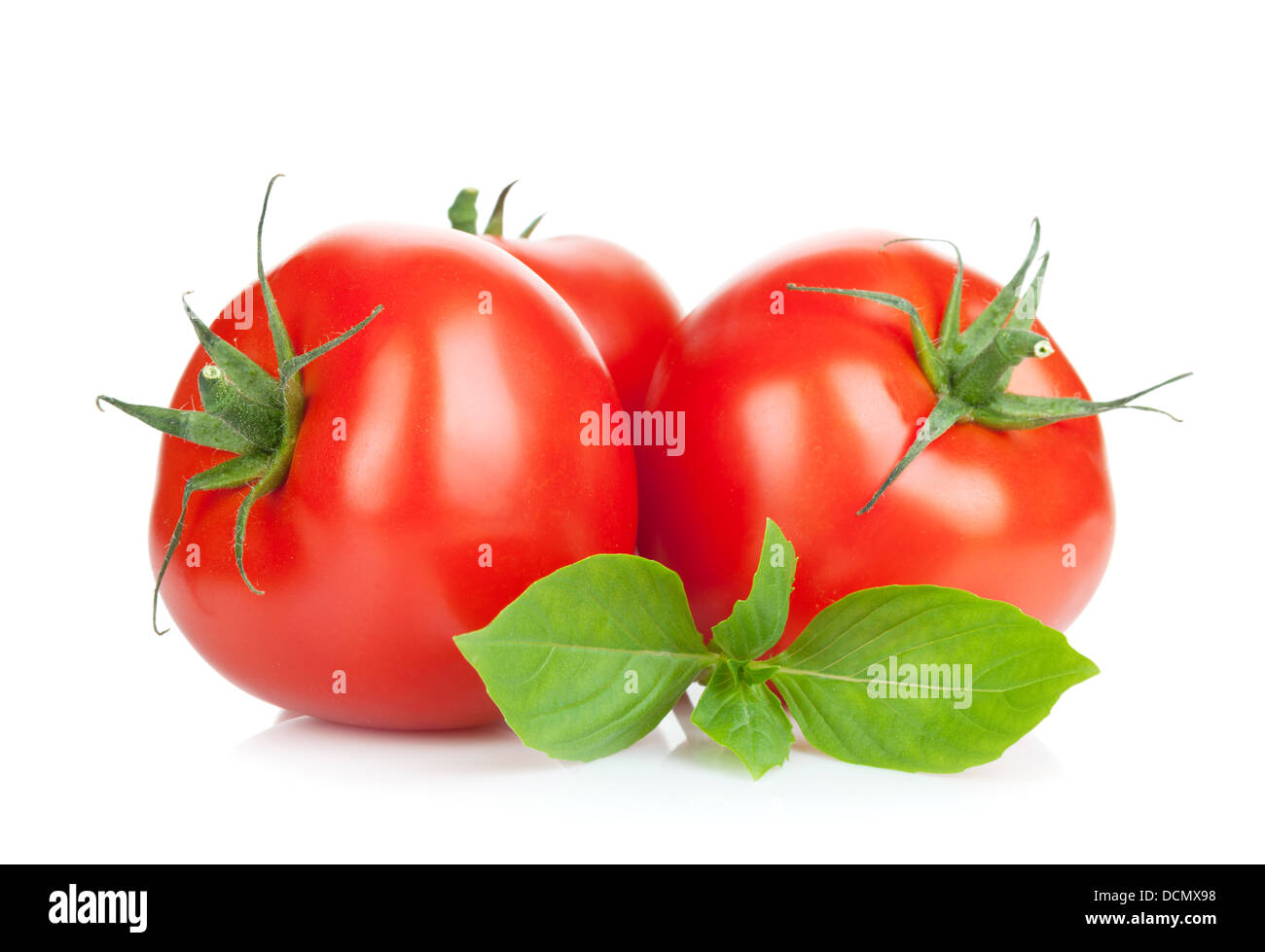 Three ripe tomatoes and basil. Isolated on white background Stock Photo ...