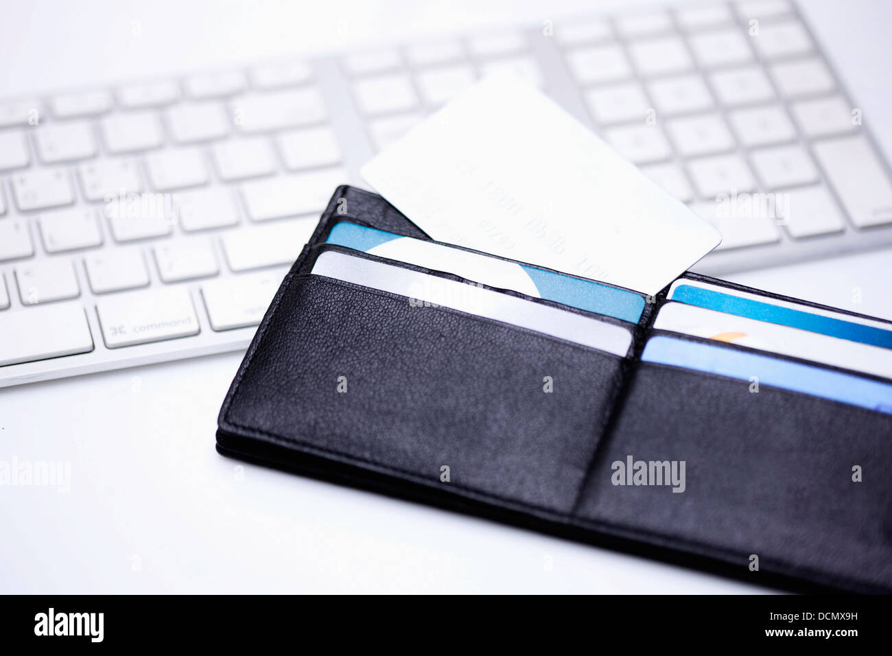a wallet on a keyboard Stock Photo - Alamy
