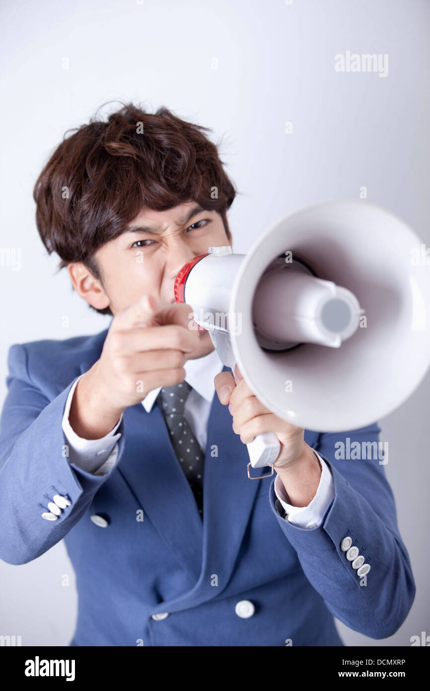 a man shouting through a megaphone Stock Photo - Alamy