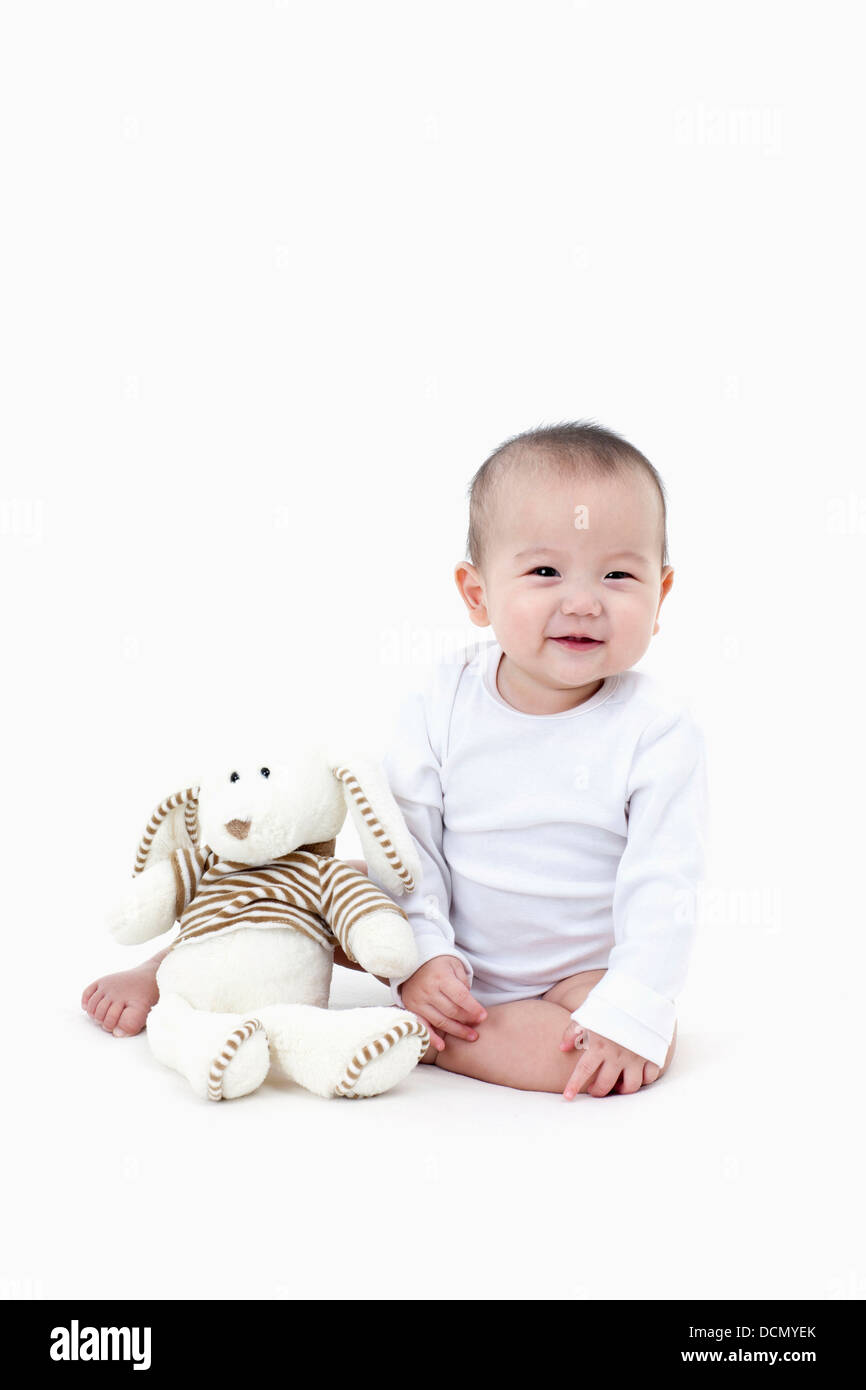 a baby with a stuffed animal toy Stock Photo Alamy